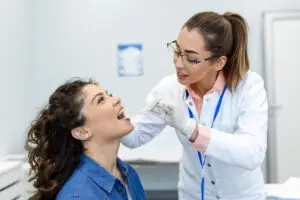 Periodontist examining a patient's gums during a periodontal evaluation for early detection of gum disease.